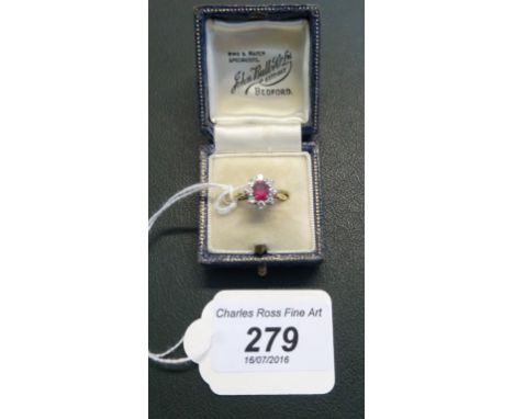 An 18 carat gold ring, set with oval cut ruby surround by eight diamonds.