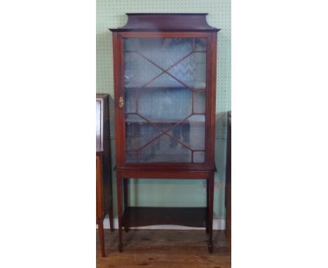 An Edwardian mahogany and inlaid display cabinet, the single astral glazed door over tapering supports with shelf (70cm).