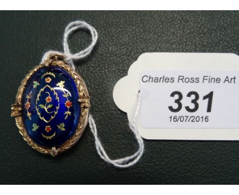 A 9 carat gold locket, the cover having blue enamel decoration.