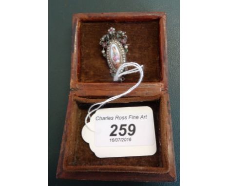 A late Victorian/Edwardian pendant with pin mount, set with a central oval hand painted mother of pearl panel depicting a you