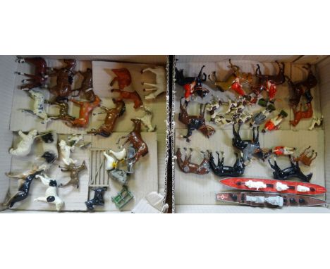A quantity of painted lead animal figurines to include Britains example and a hunting group with riders on horseback with hou
