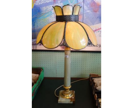 A large gilt and onyx table lamp, the green opaque petal shade over a Corinthian-style column on stepped square base.