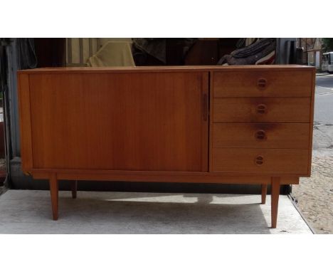 A teak sideboard, the sliding cupboard door revealing single shelf interior, beside four drawers, internal label reading Mobe