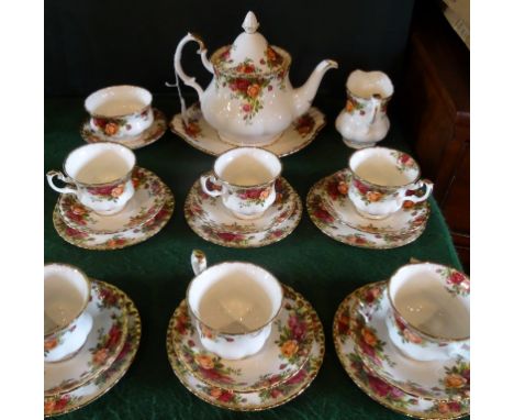 A Royal Albert Old Country Roses tea service, a six place setting comprising: trios, teapot, cake plate, open sugar bowl and 