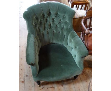 A Victorian green upholstered button back fireside chair.
