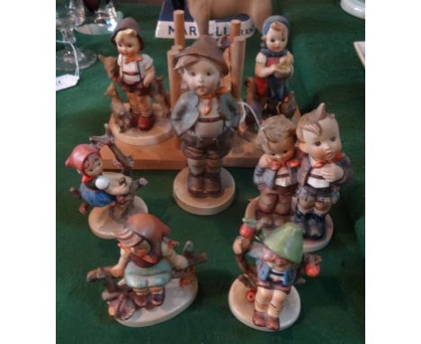 Seven Goebel/Hummel figurines, to include: a pair modelled as bookends, the tallest (15cm). Condition Report: Minor chips and