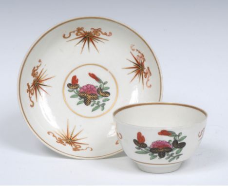 A Worcester Lightening pattern tea bowl and saucers, the centre with stylised flower spray, the border with ribbon tied burst