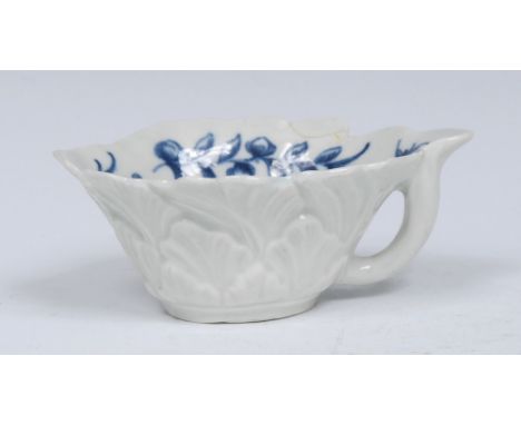 A Worcester Formal Rose pattern butter boat, moulded in relief, painted in underglaze blue with a rose and trailing sprays of