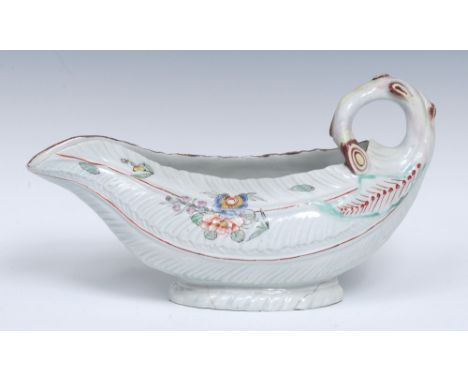 A Worcester Cos Lettuce sauce boat, curved stalk handle, decorated with flowers, buds and leaves in pastel shades, the interi