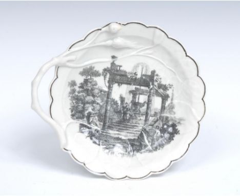 A Worcester shaped circular Blind Earl dish, moulded in relief with veins, the rustic crabstock handle with rosebuds, printed