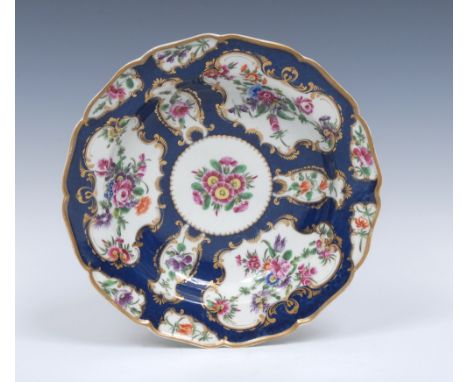 A Worcester shaped circular dessert plate,  painted with alternating fan and vase shaped gilt scroll reserves with  garlands 