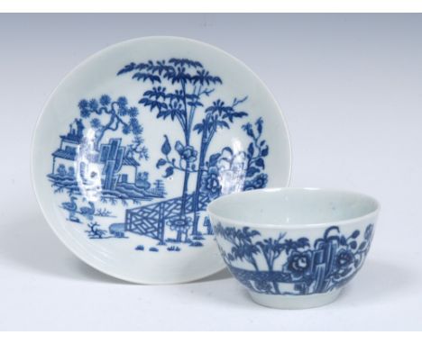 A Worcester Plantation pattern tea bowl and saucer, painted with  fence, bamboo, pine tree, building and ducks, workman's mar