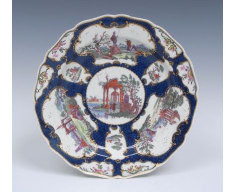 A Worcester shaped circular dessert plate, in the Meissen manner, printed in puce and overpainted in bright enamels with figu