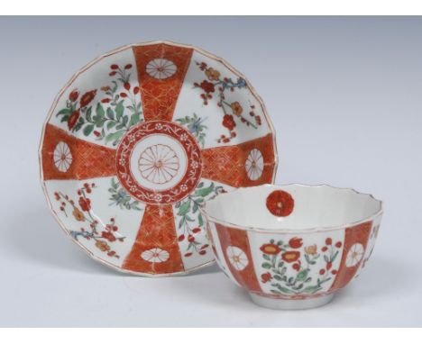 A Worcester Scarlet Japan pattern fluted tea bowl and saucer, decorated in the typical manner with alternating orange panels 