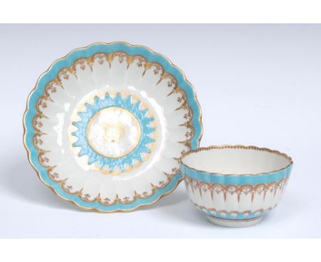 A Worcester French shape fluted small tea bowl and saucer, decorated with bright turquoise enamel borders edged with gilt `C'