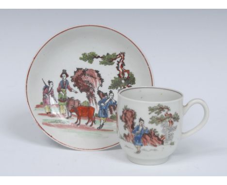 A Worcester Red Bull pattern coffee cup and saucer, coloured and outlined in black with bull, figures, tree and large rock an