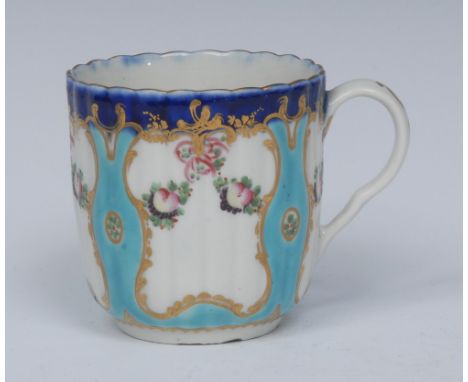 A Worcester French shape reeded coffee cup, with four lobed panels containing two swags of fruit and red berries, reserved on
