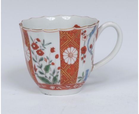 A Worcester Scarlet Japan pattern fluted coffee cup, decorated in the typical manner with alternating orange panels with a gi