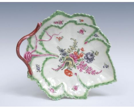 A Worcester Vine Leaf moulded dish, the veins in relief, finely painted with a central bouquet of flowers, surrounded by smal