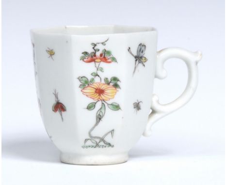 A Worcester octagonal coffee cup, delicately painted in the Chinese manner with alternating panels of flowering plants and in