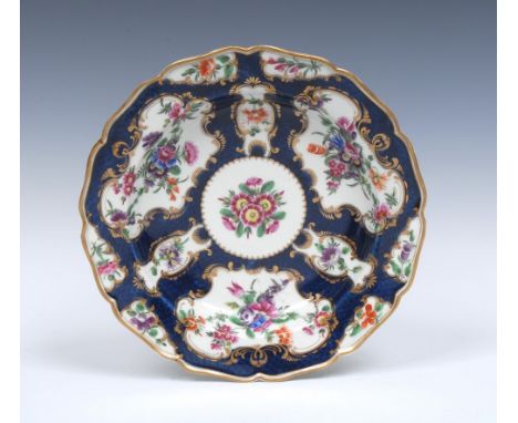 A Worcester shaped circular dessert plate,  painted with alternating fan and vase shaped gilt scroll reserves with  garlands 