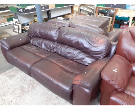 An oxblood red leather three seater sofa, two seater sofa and matching footstool 