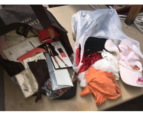 A bag of vintage stockings, suspenders and misc clothing items. 