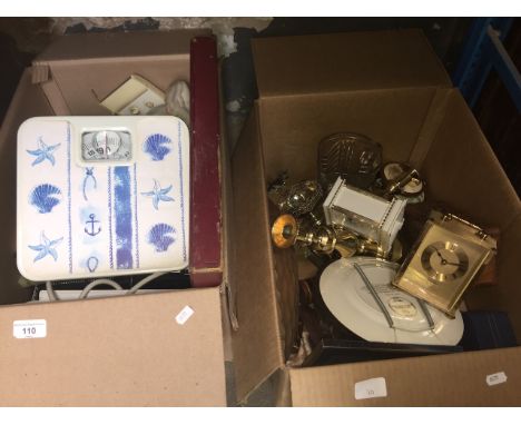 Two boxes of assorted items including glassware, brassware, bathroom weighing scales, two carriage style clocks, tape recorde
