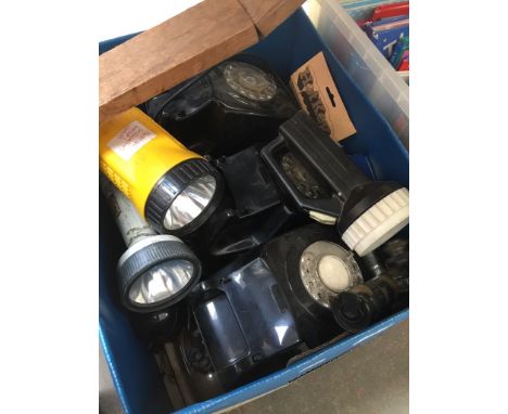 A box containing five vintage telephones and various torches. 