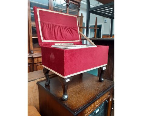 A vintage sewing box stool containg various items, thread, needles, books etc 