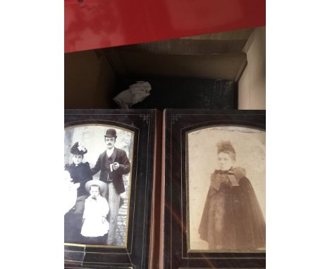 A box of vintage photograph albums and photographs. 