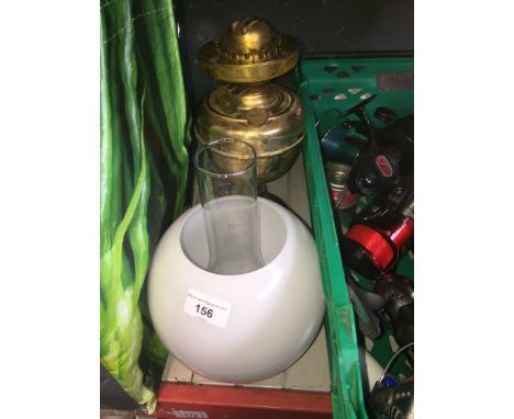 A brass paraffin lamp with funnel and shade. 