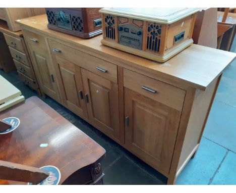 A light oak sideboard, length 176cm, depth 42cm and height 86.5cm 