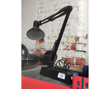 A black anglepoise lamp. 