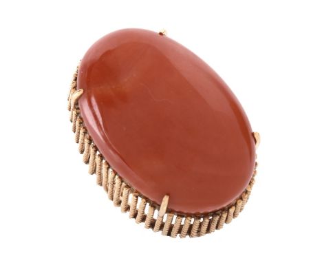 Large Oval Cabochon Red Coral and 14 Karat Yellow Gold Ring. Stamped 14K. Coral measures 35 x 24mm. Ring size 7-1/4. Approx. 