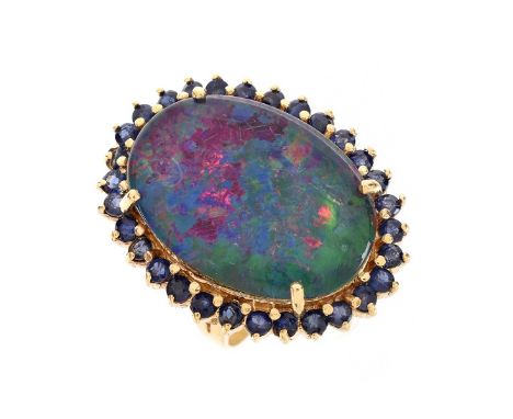 Vintage Large Black Opal Doublet, Sapphire and 18 Karat Yellow Gold Ring. Opal measures 24mm x 17.5mm. Opal with good play of