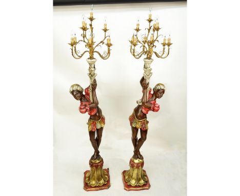 Pair of Mid Century Polychrome Wood Carved Blackamoor Torchieres. Decorated with electrified 10 arm gilt metal candelabra top