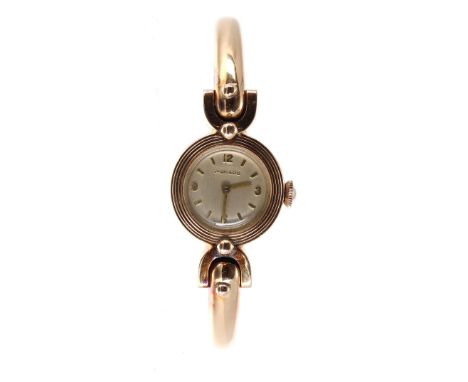 Movado 18k sprung hinged lady's bangle watch, signed silvered dial with Arabic quarter numerals and baton markers, cal. 7165 