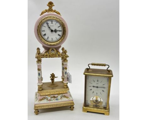 Vintage porcelain floral mantel clock with brass gilt trim and cherub figurine. [33cm high]Along with a Schatz carriage clock
