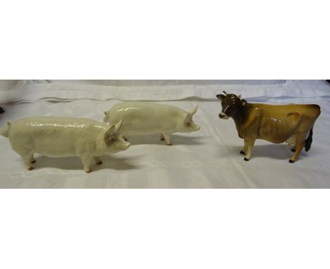 A Beswick Model of a Jersey cow and two Beswick pigs (a/). 