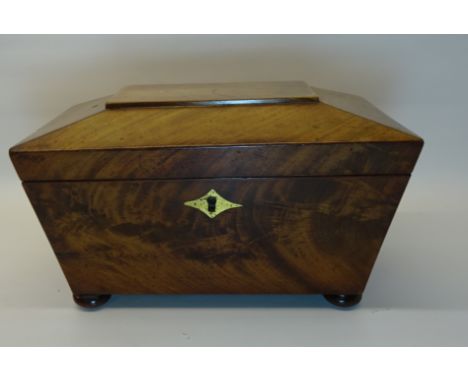 A Victorian mahogany sarcophagus shape Tea Caddy with brass keyplate and compressed bun feet.  10" (25cms) wide.