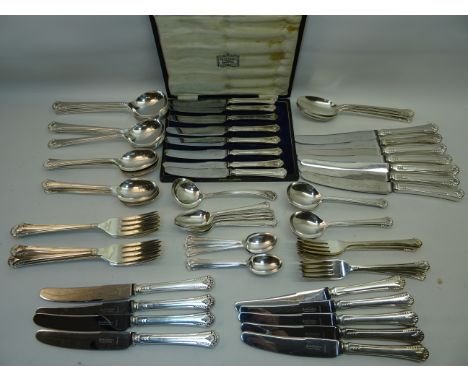 A suite of plated Table Cutlery with shell finials, comprising sixteen table knives, eight dessert knives, eight table forks,