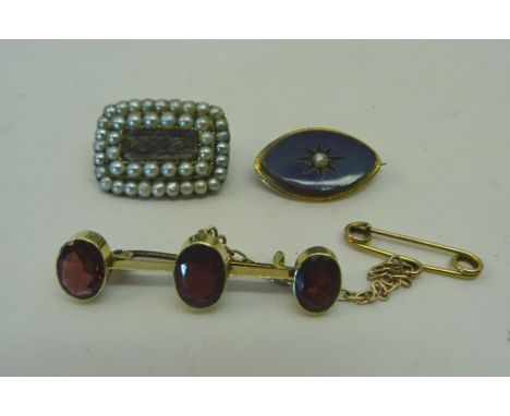 A 19th Century Memento Mori Brooch set with a hair panel and seed pearls and inscribed '1837', a navette shaped brooch with s