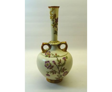 A Victorian Royal Worcester two handled baluster Vase painted with sprays of flowers with gilded handles on a blush ivory gro