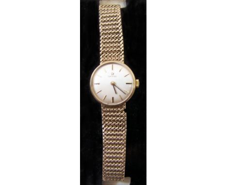 A ladies Omega Wristwatch with baton numerals, in gold case and on gold flexible strap.