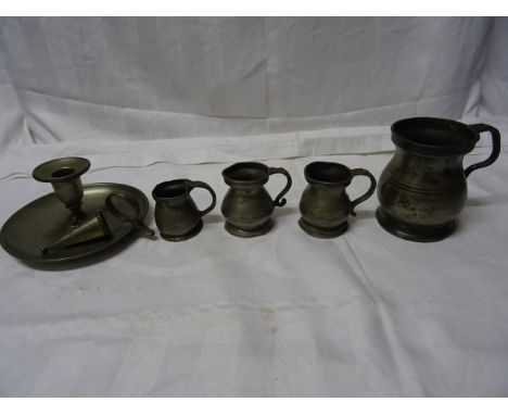 Four pewter Baluster Measures, largest 1/3 of a pint and a pewter chamber candlestick. 