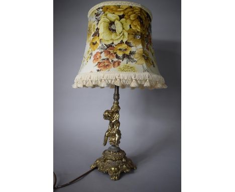 A Cast Gilt Metal Lamp with Cherub and Scrolled Support - Total Height 57cms High with Shade 