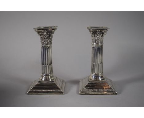 A Pair of Silver Corinthian Column Candlesticks on Stepped Square Bases (Filled), One Inscribed 'Grindelwald Cup', 16cms High