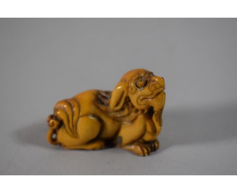 A 19th Century Carved Ivory Netsuke in the Form of a Temple Lion, Signed to Base, 5cms Long 