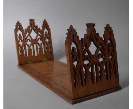 An Edwardian Oak Book Slide with Pierced Architectural Decoration, 36cms Wide 